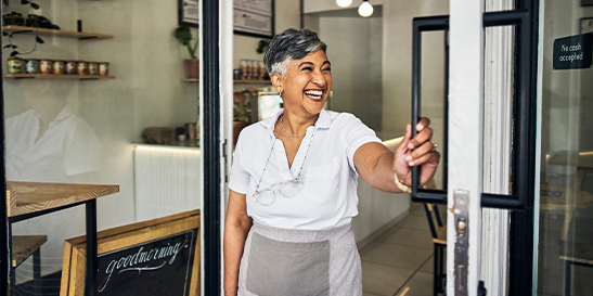 Smiling person opening the door
