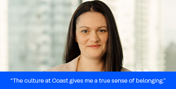 Woman with long brown hair in a beige suit and black shirt smiling. Text on a blue background reads, "The culture at Coast give me a true sense of belonging.
