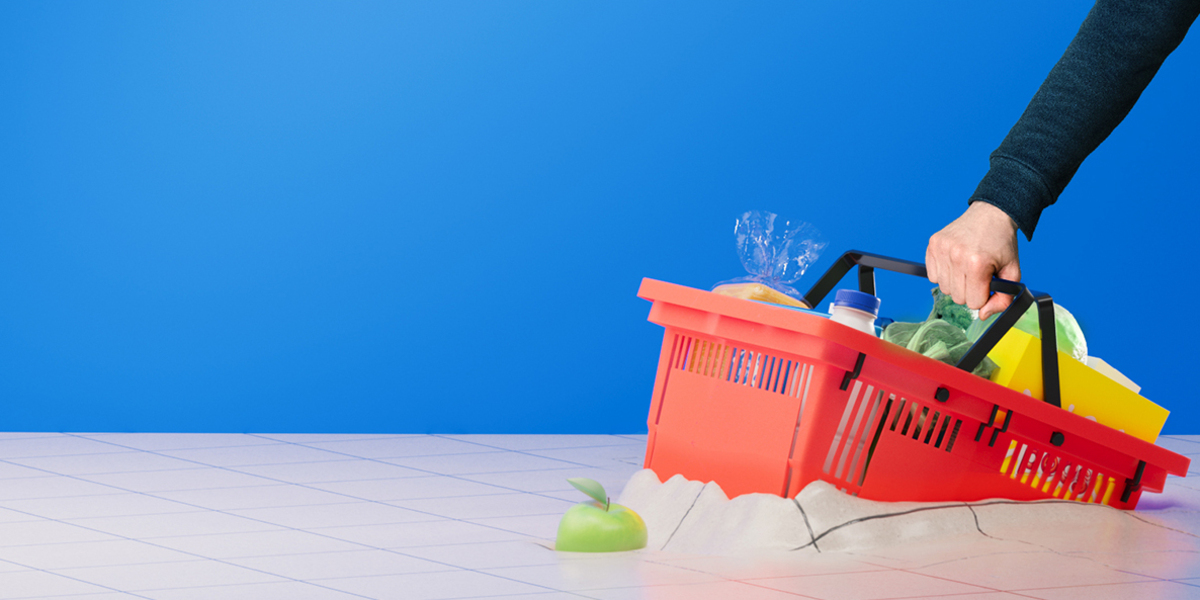 Arm holding a grocery basket that is stuck in a tiled floor.  