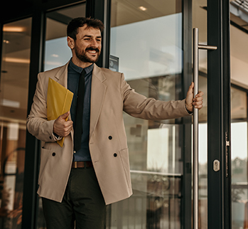 Man in suit holding door